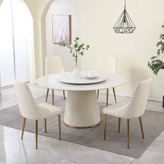 Modern white marble round dining table with plush cream chairs and gold legs