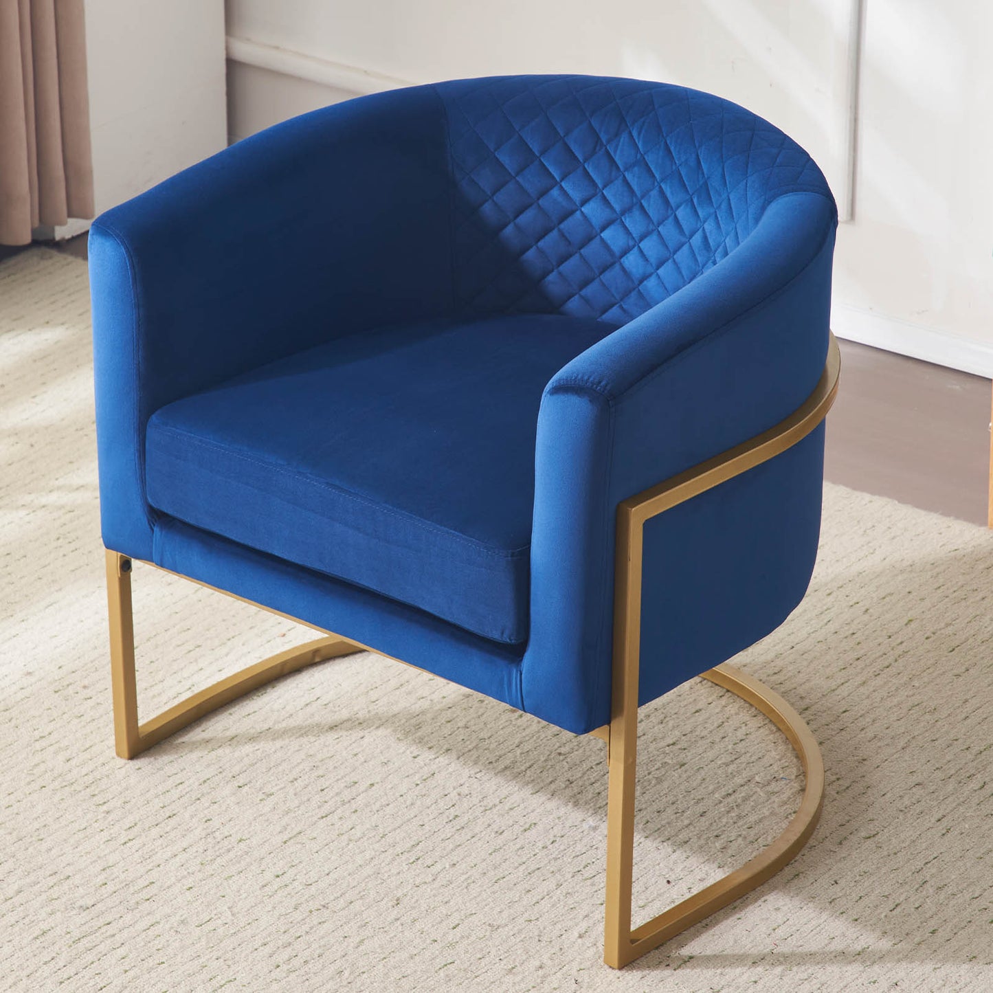 Royal blue velvet accent chair with gold frame and diamond tufted back