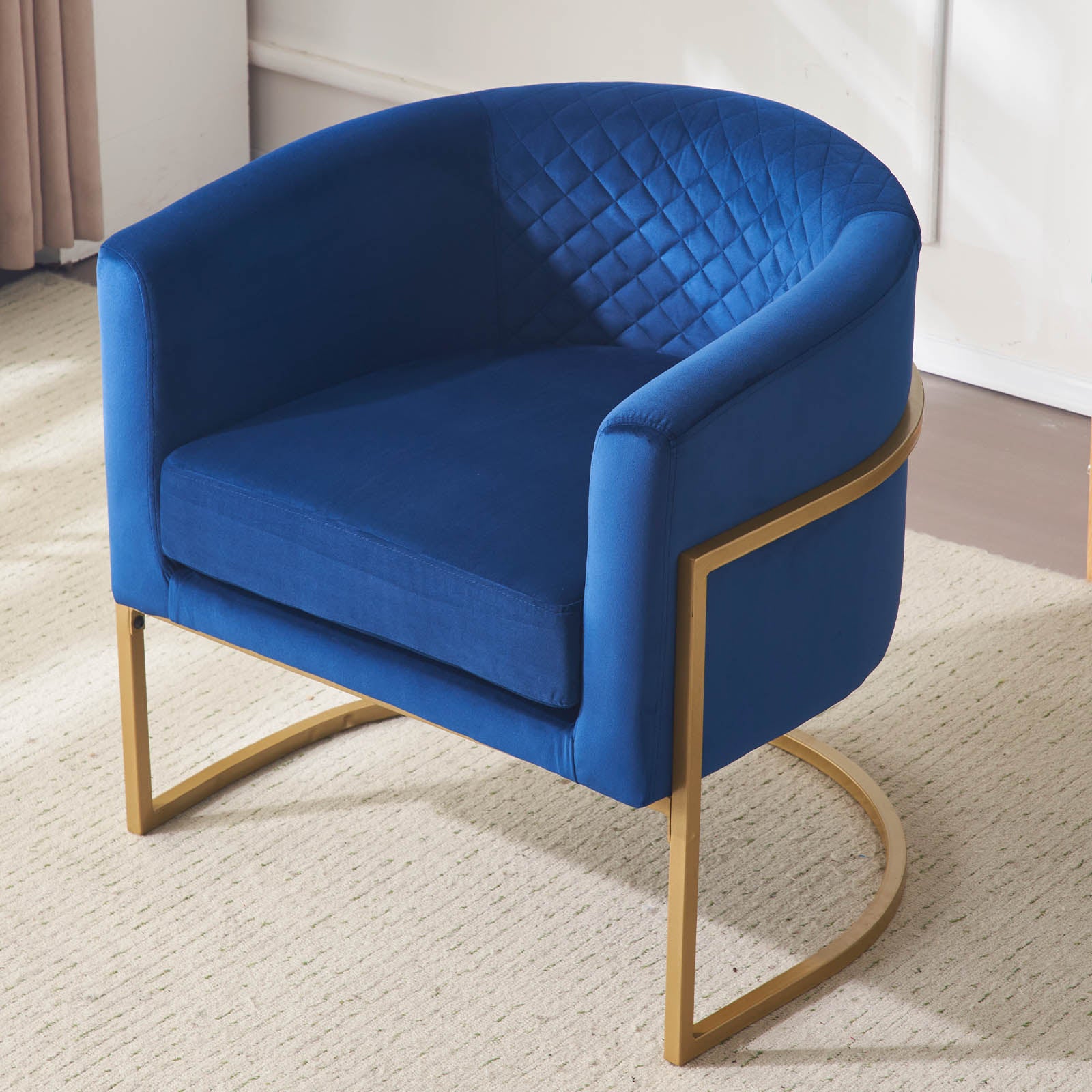 Royal blue velvet accent chair with gold frame and diamond tufted back