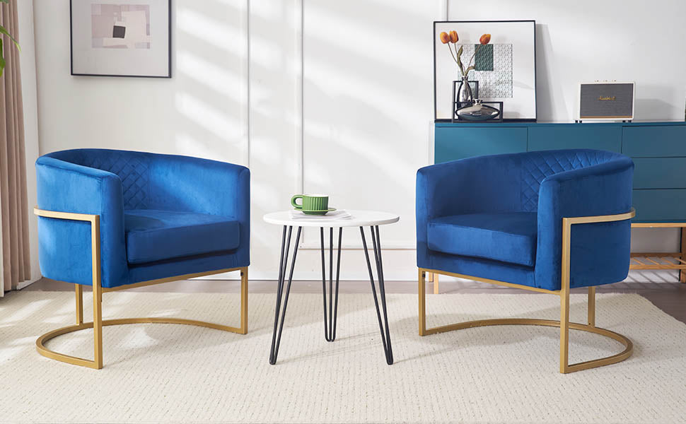 Two royal blue velvet accent chairs with quilted backrests and gold metal bases
