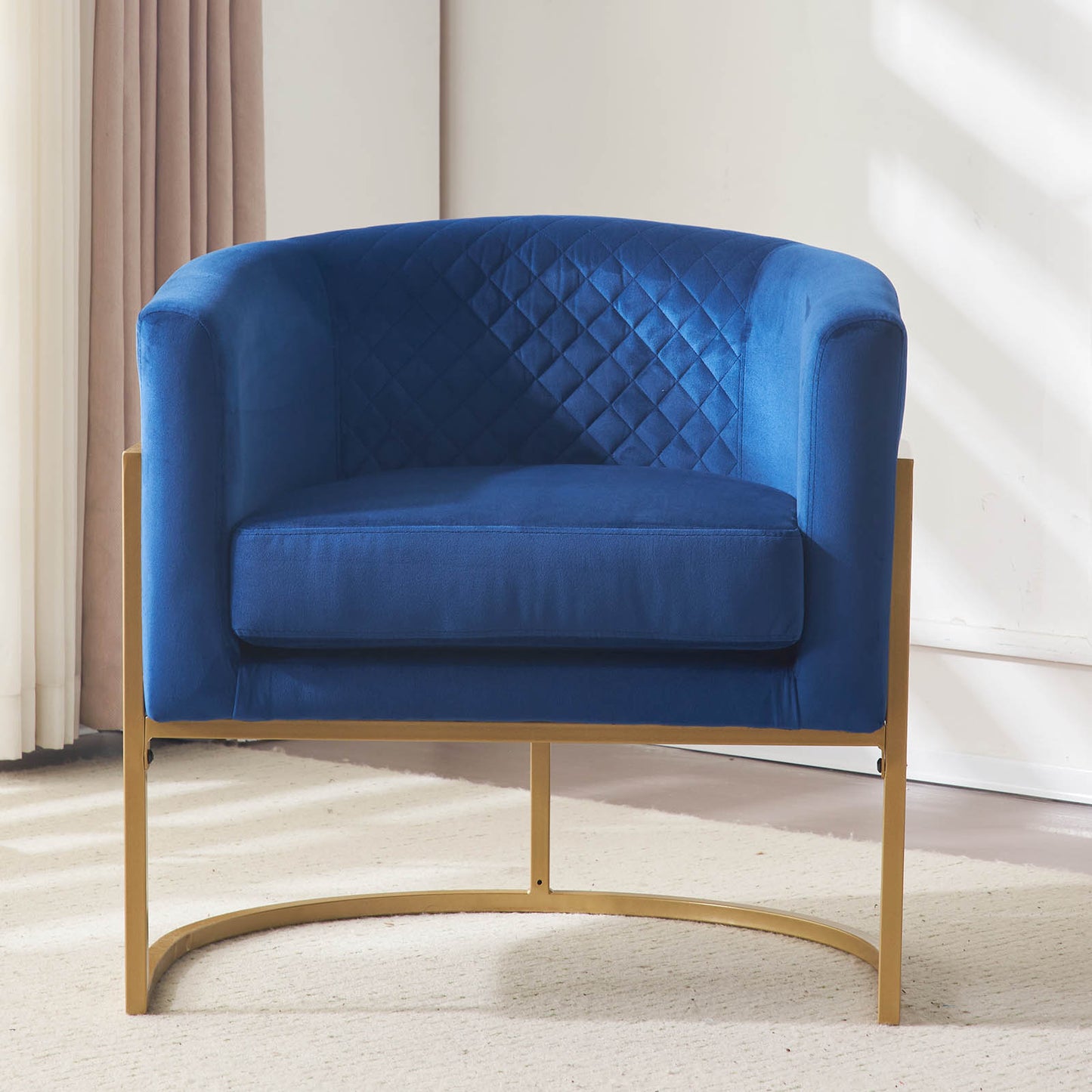 Deep blue velvet accent chair with diamond tufting and gold metal legs