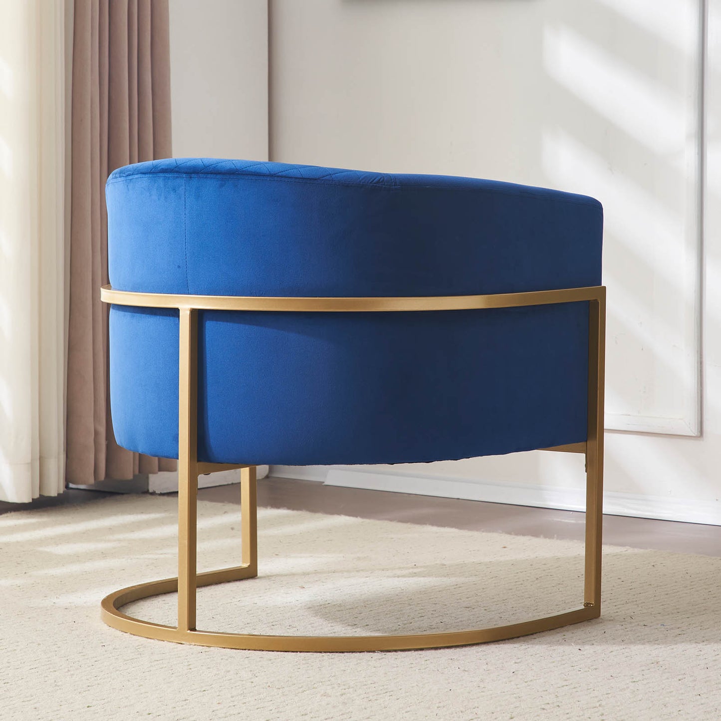 Deep blue velvet accent chair with diamond tufting and brushed gold frame