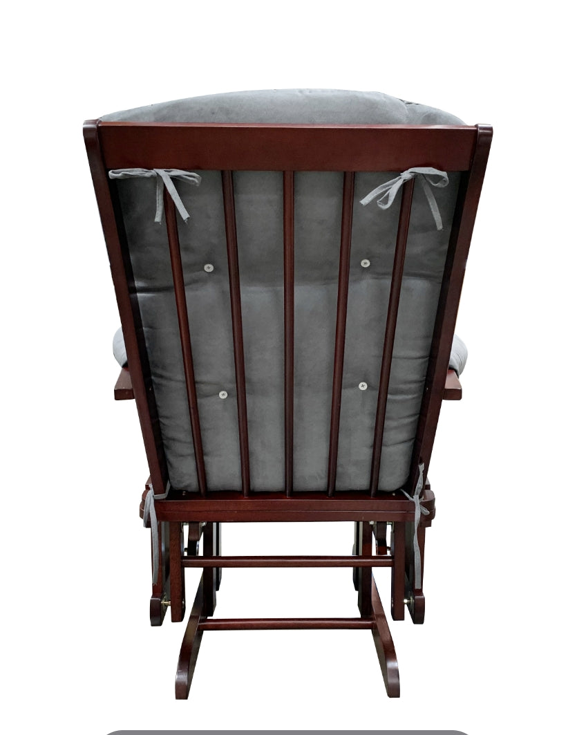 Wooden rocking chair with grey tufted cushion and tiebacks for nursery comfort