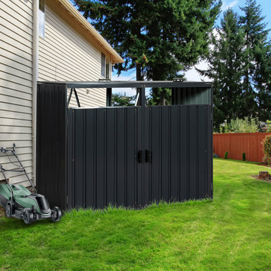 Dark gray metal outdoor storage shed with double doors and a lawnmower