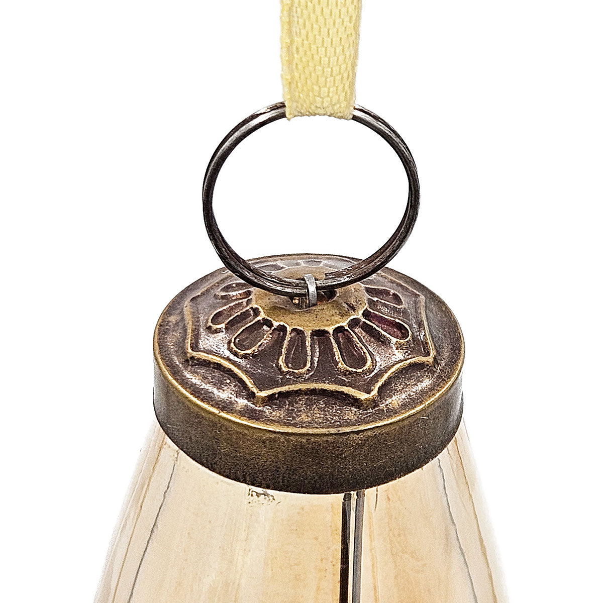 Antique brass Christmas ornament with embossed floral top and light brown ribbon hanger