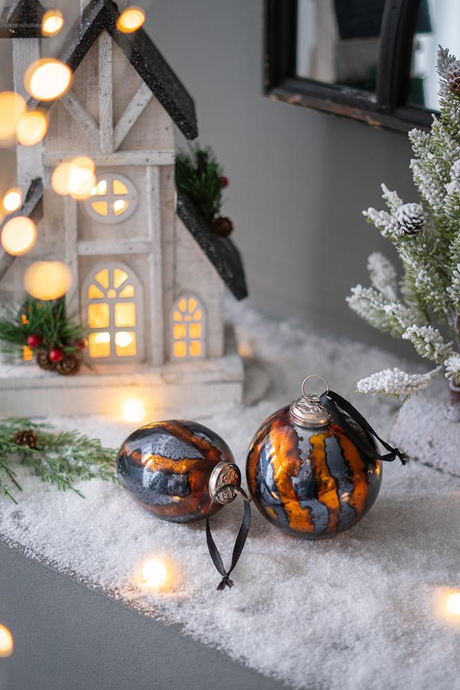Two marbled glass Christmas baubles in amber and grey perfect for festive decor