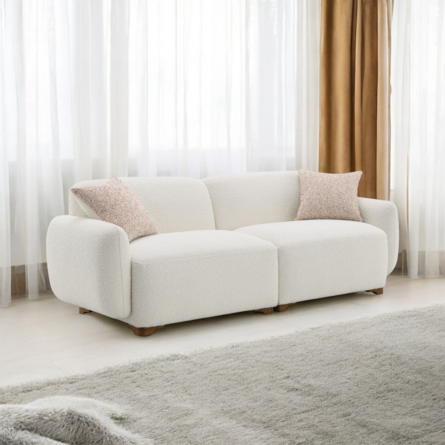 Plush white boucle fabric sectional sofa with wooden legs and textured throw pillows