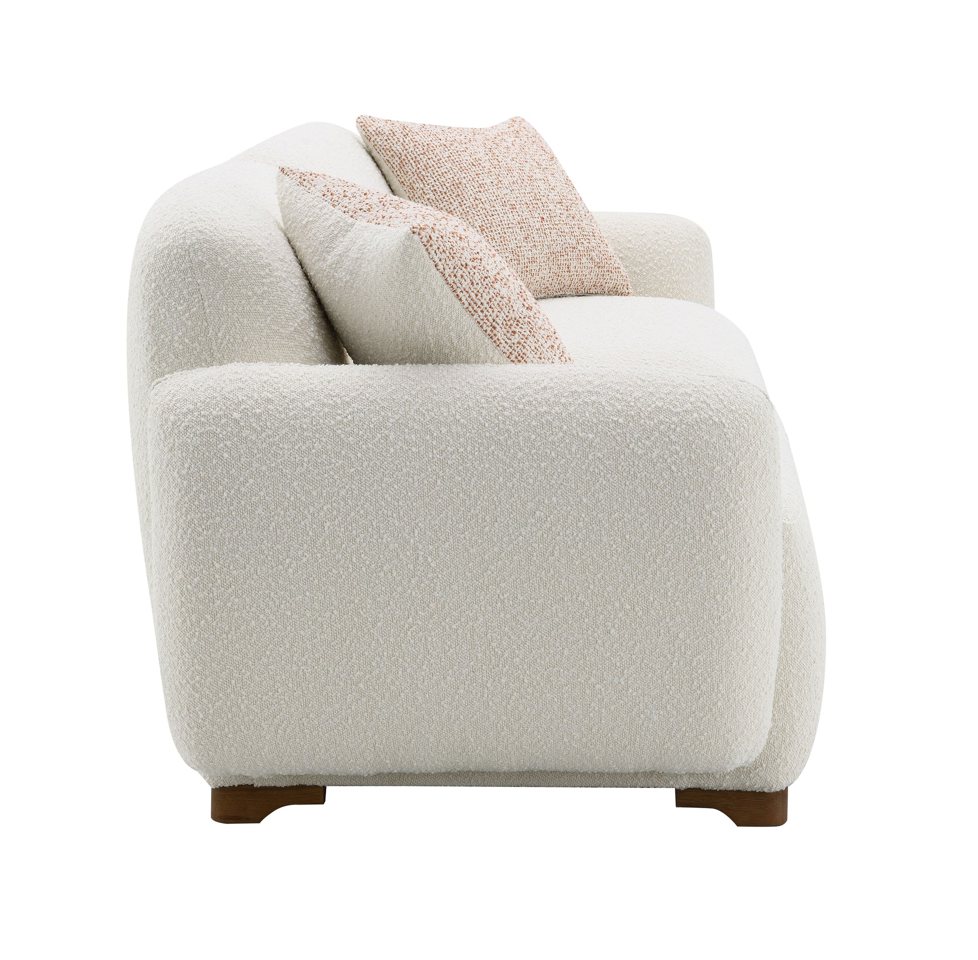 Plush ivory boucle sofa with abstract terracotta patterned pillows a cozy seating option