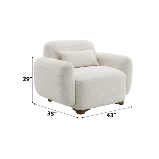 Plush cream boucle armchair with rounded arms and included lumbar pillow perfect for a cozy reading nook