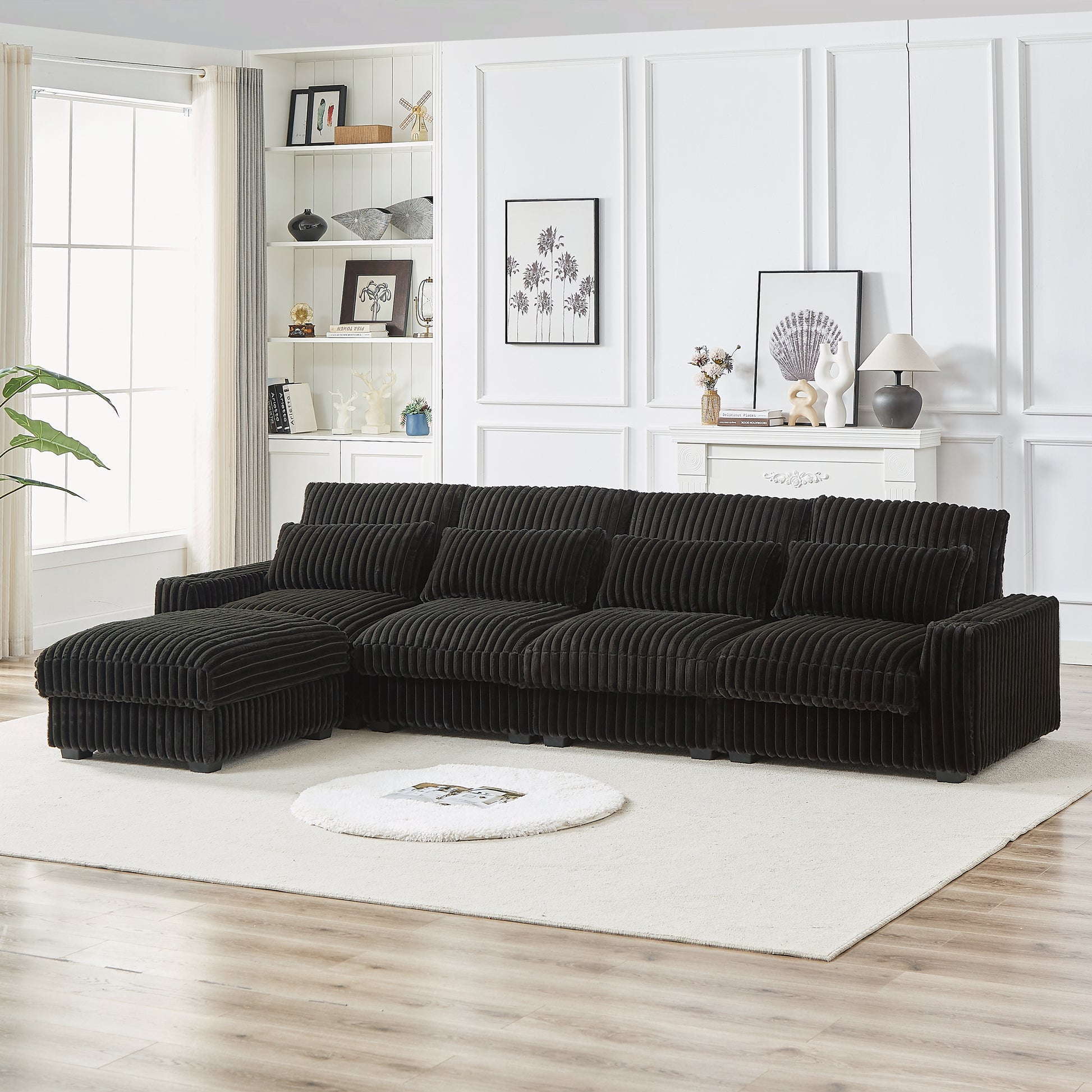 Dark grey corduroy sectional sofa with plush cushions and ottoman