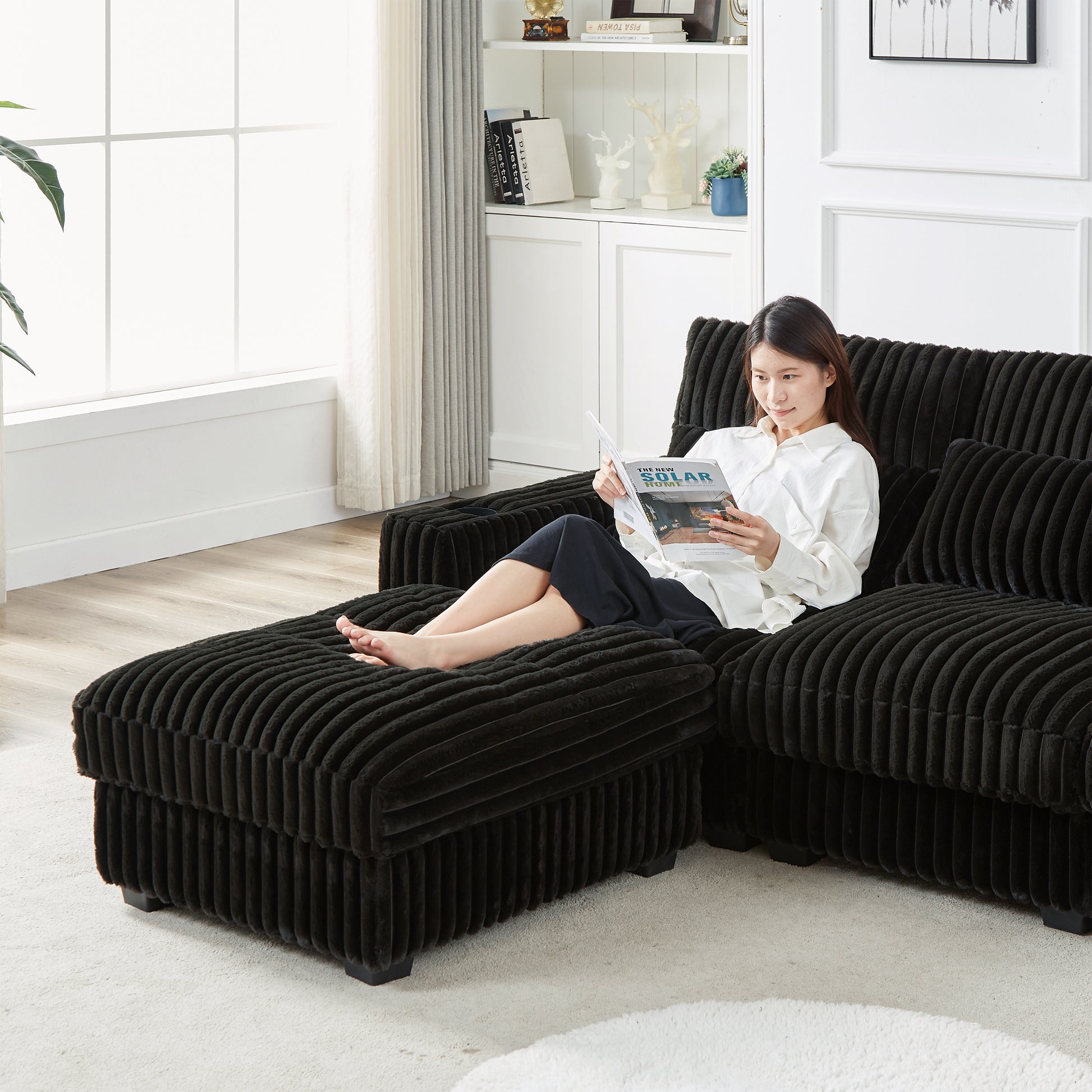 Black corduroy sectional sofa with chaise lounge and ottoman perfect for modern living rooms