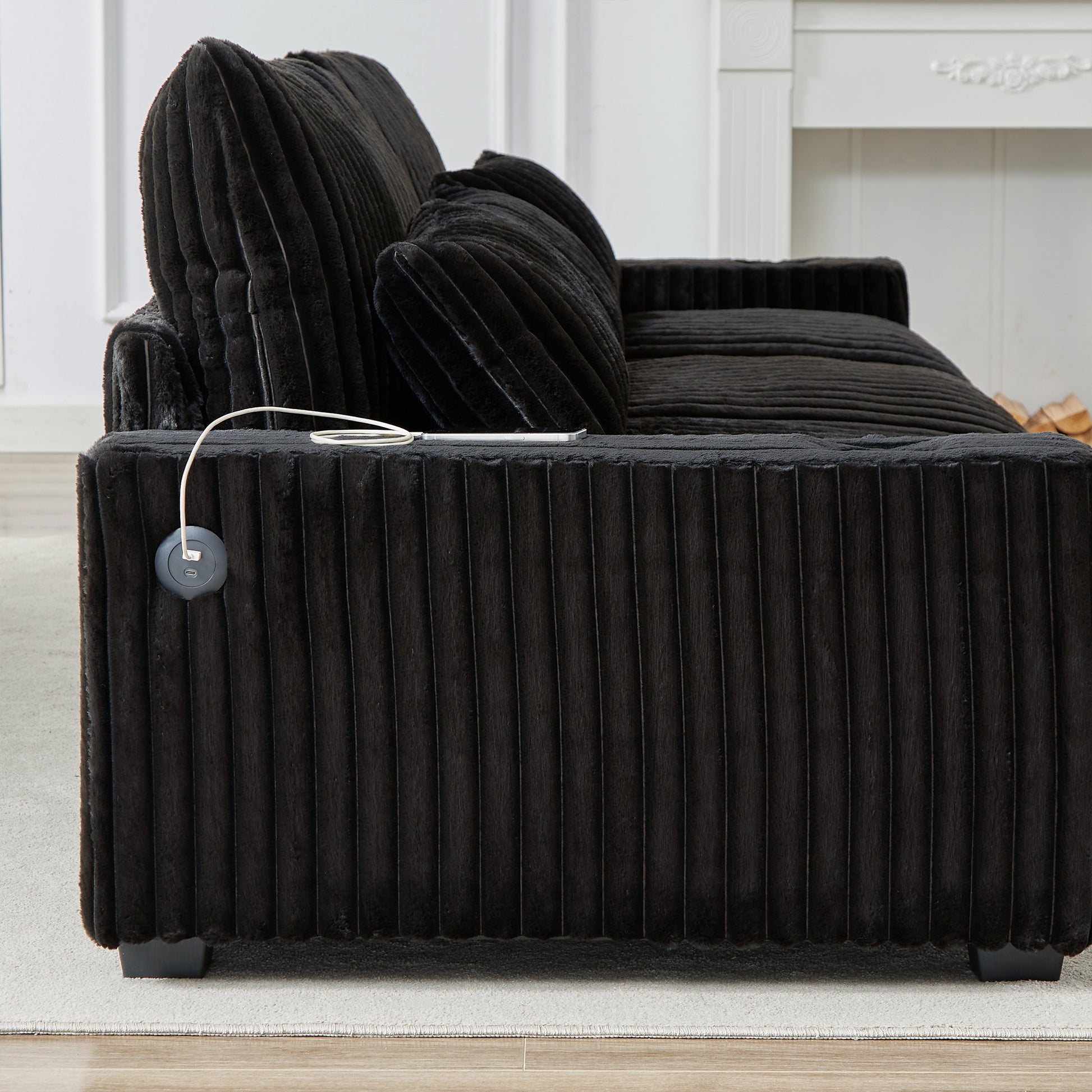 Plush black corduroy accent chair with builtin USB charging port for modern convenience