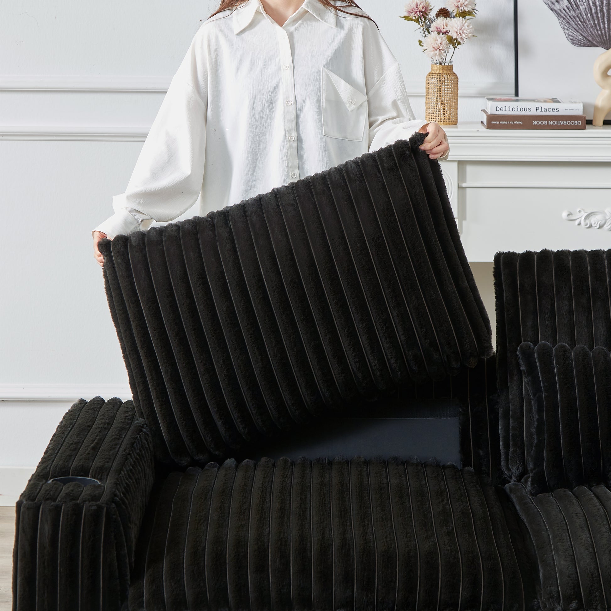 Plush black corduroy fabric recliner with a removable seat cushion showing detailed stitching