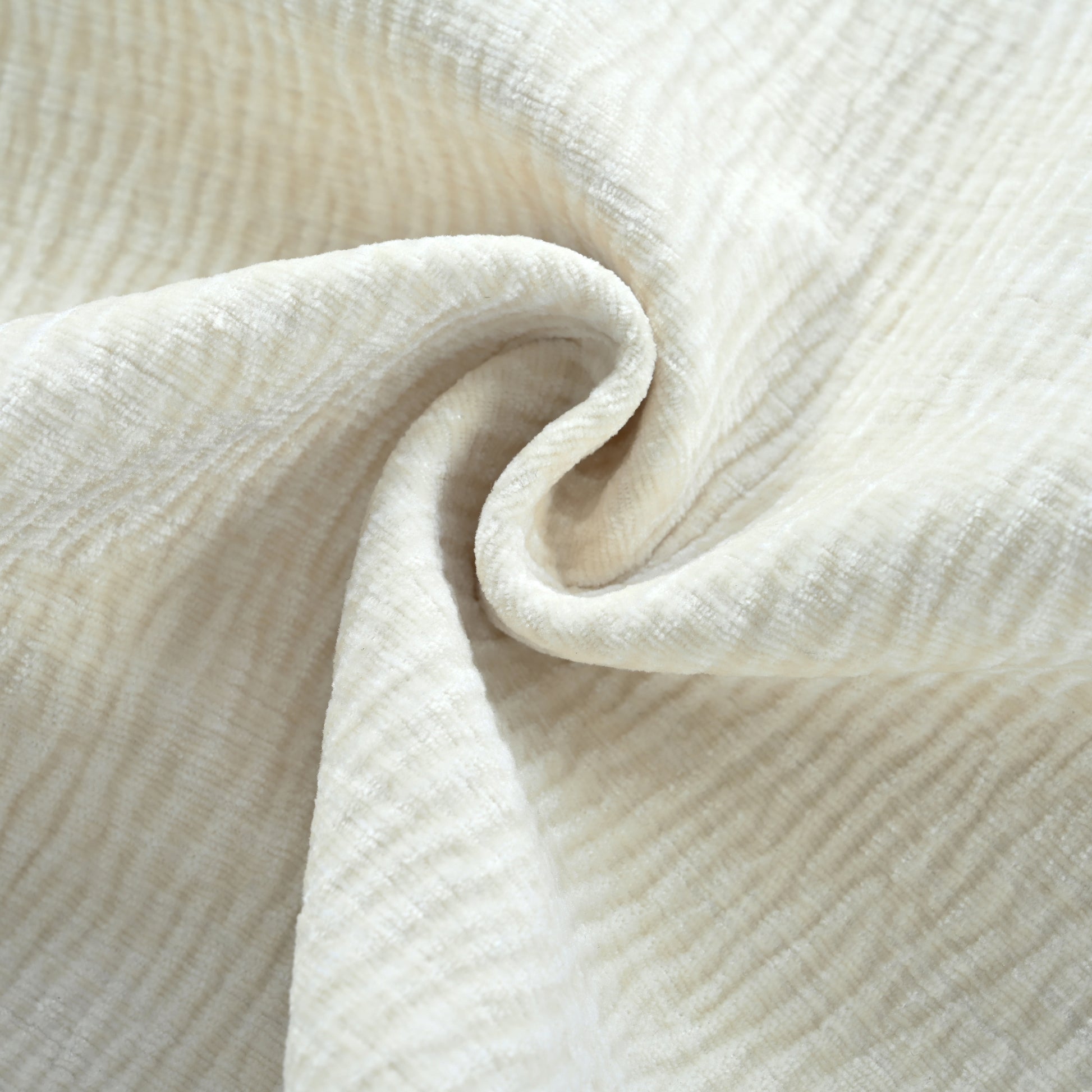 Closeup of creamy white chenille fabric with a subtle ribbed texture ideal for upholstery
