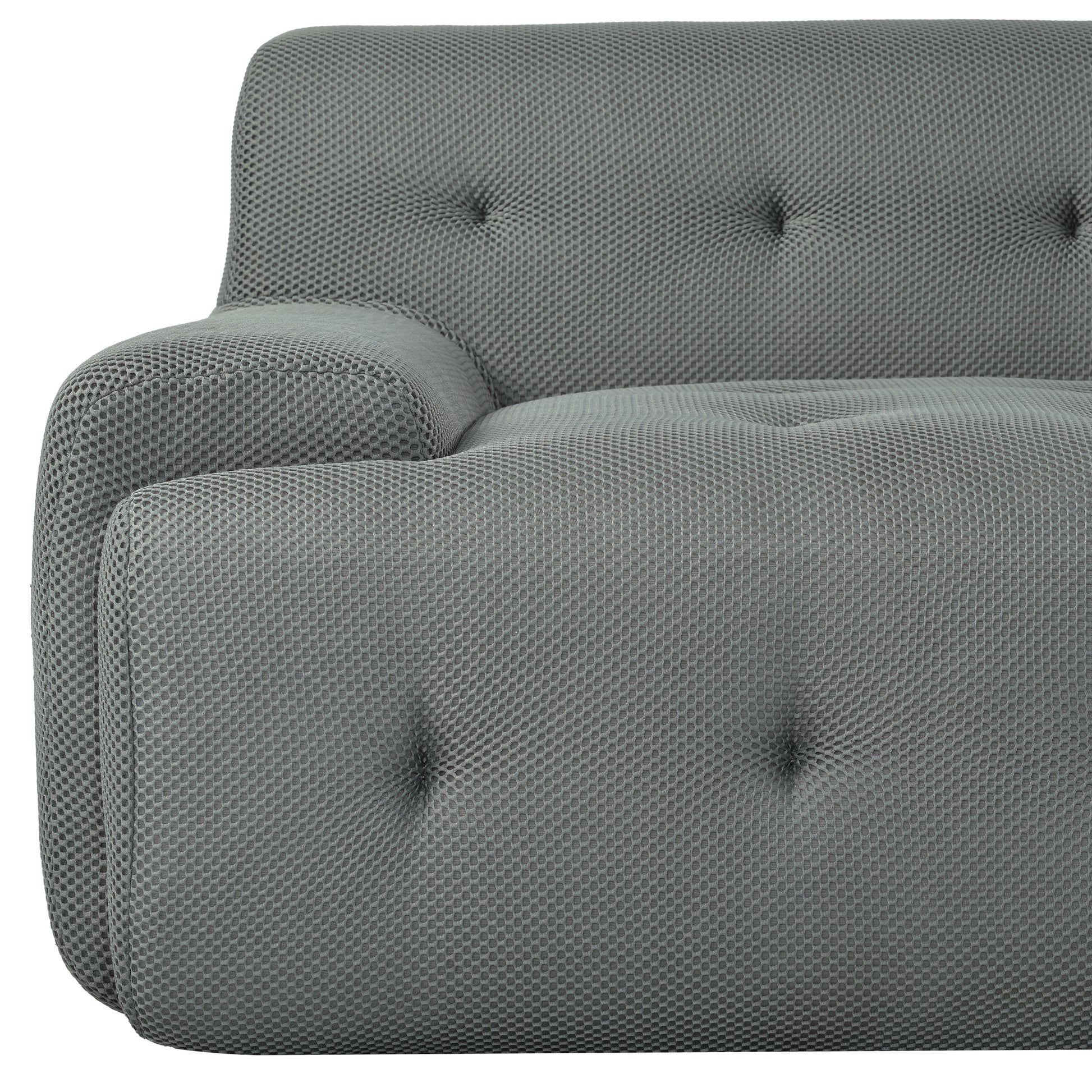 Tufted grey fabric sofa armrest with textured hexagonal pattern