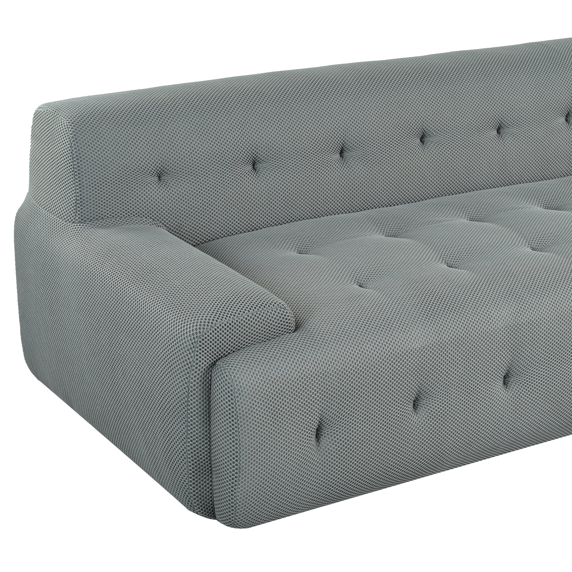 Modern grey tufted sofa with textured fabric and a minimalist design
