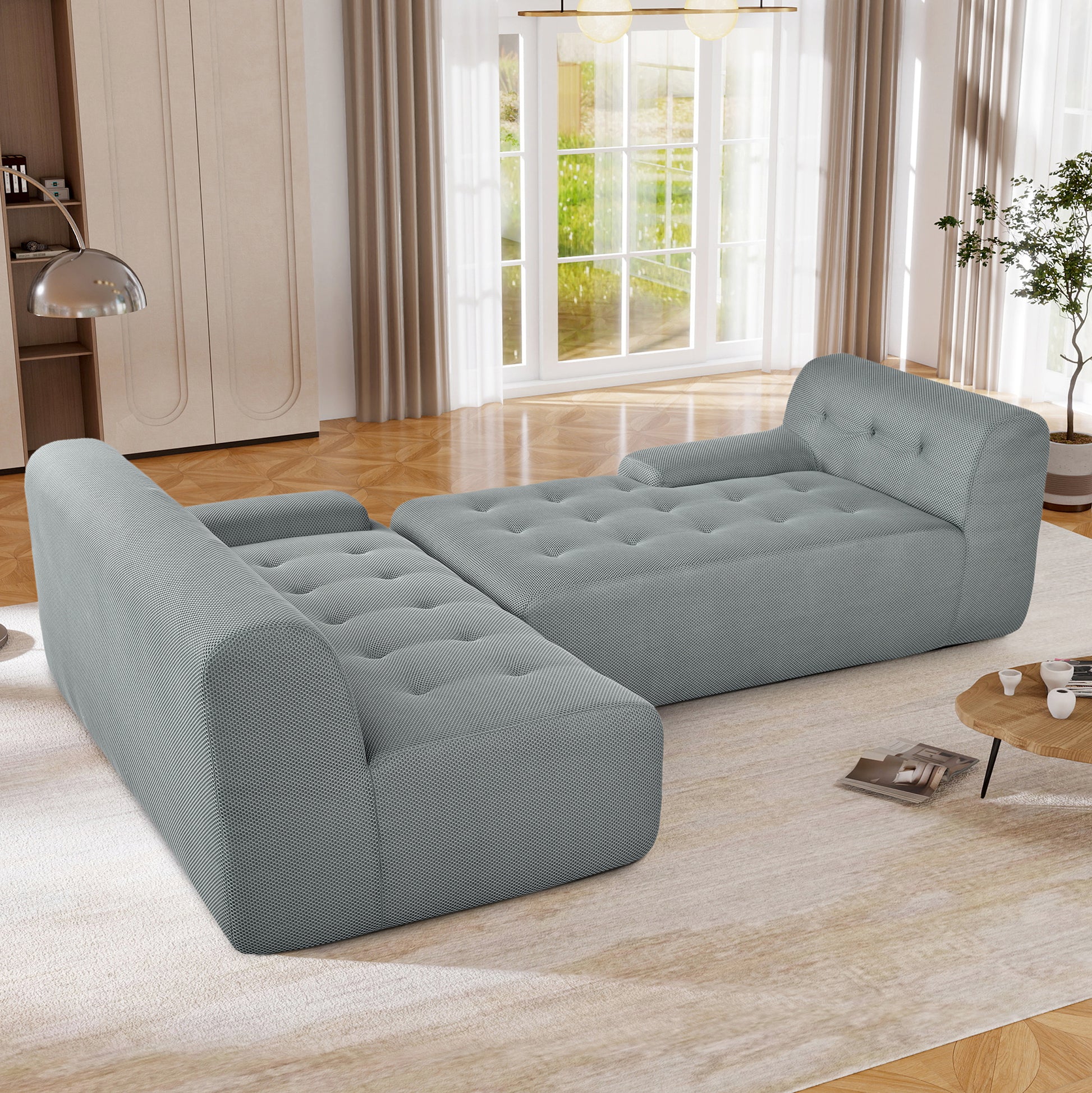 Modern light grey modular sectional sofa with tufted cushions and sleek armrests