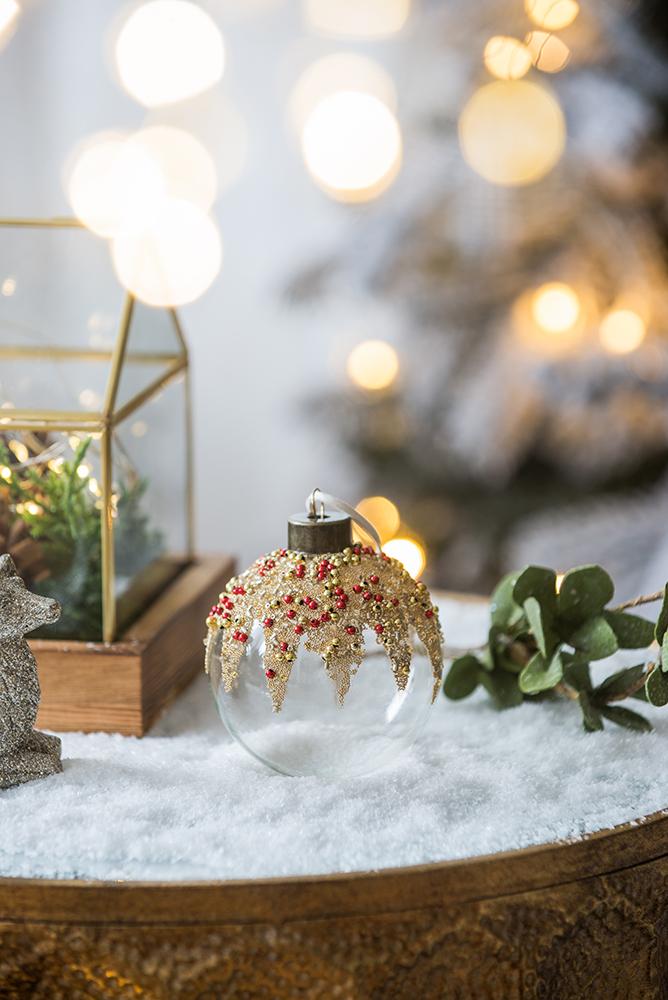 Clear glass Christmas ornament with gold bead trim and red accents