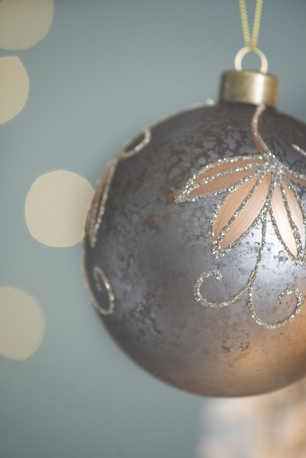 Matte gray Christmas ornament with rose gold floral design and glitter accents