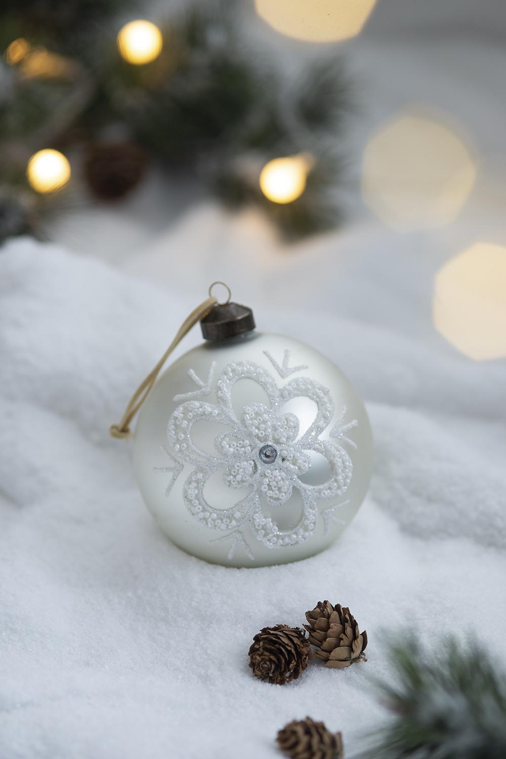 White bauble with intricate snowflake design perfect for festive Christmas tree decor