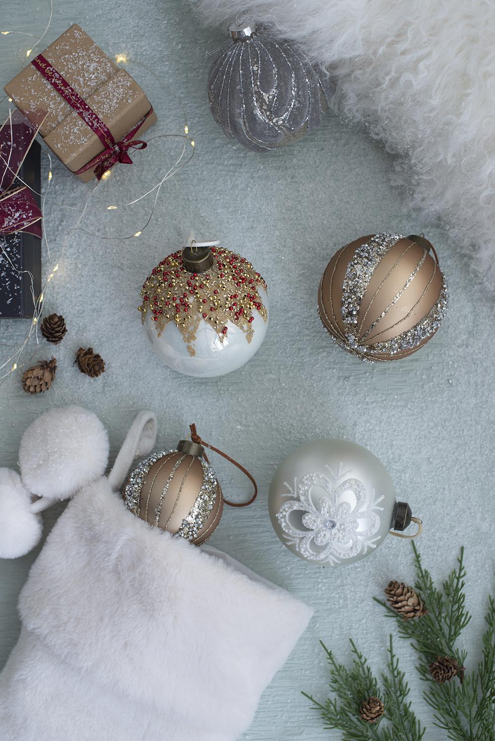 White glass Christmas ornament with intricate silver snowflake detail