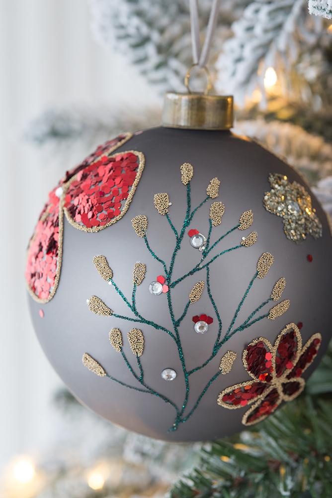 Gray Christmas ornament with red sequin floral design and gold beaded branches