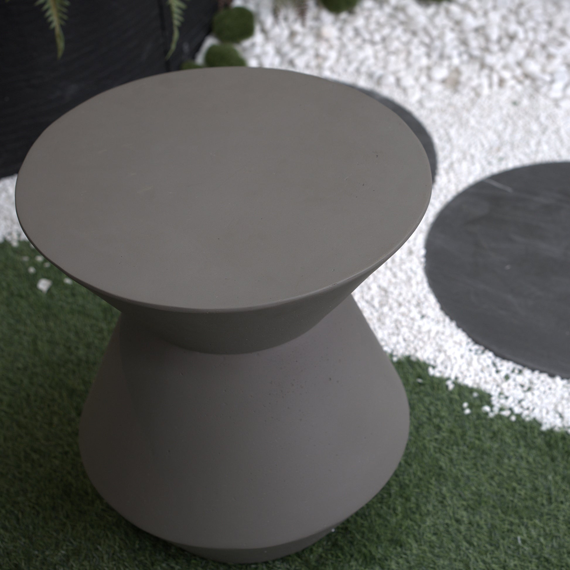 Hourglassshaped grey concrete accent table for modern patio decor
