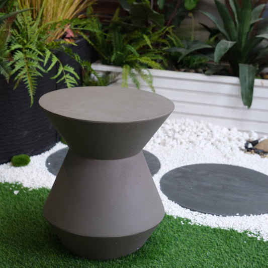 Modern hourglassshaped outdoor side table in taupe concrete