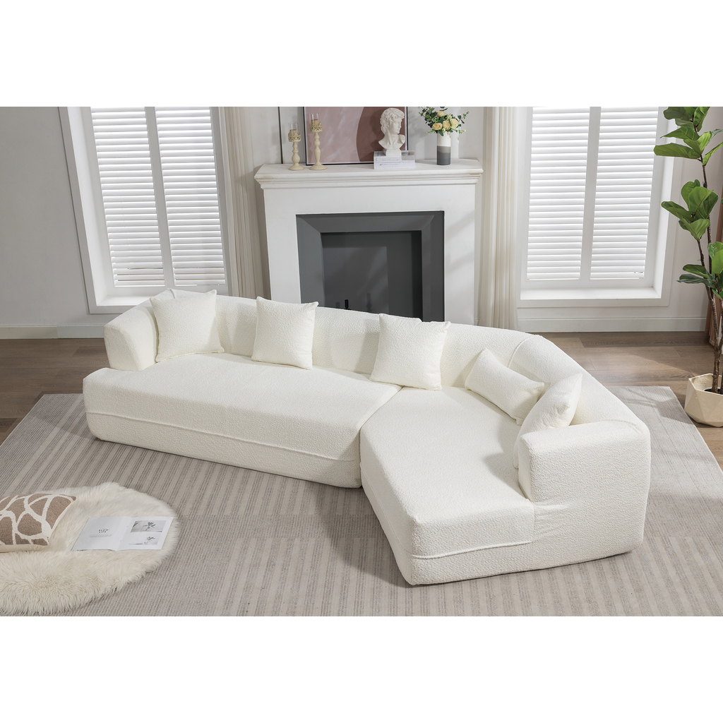 Plush white sectional sofa with textured upholstery and matching accent pillows