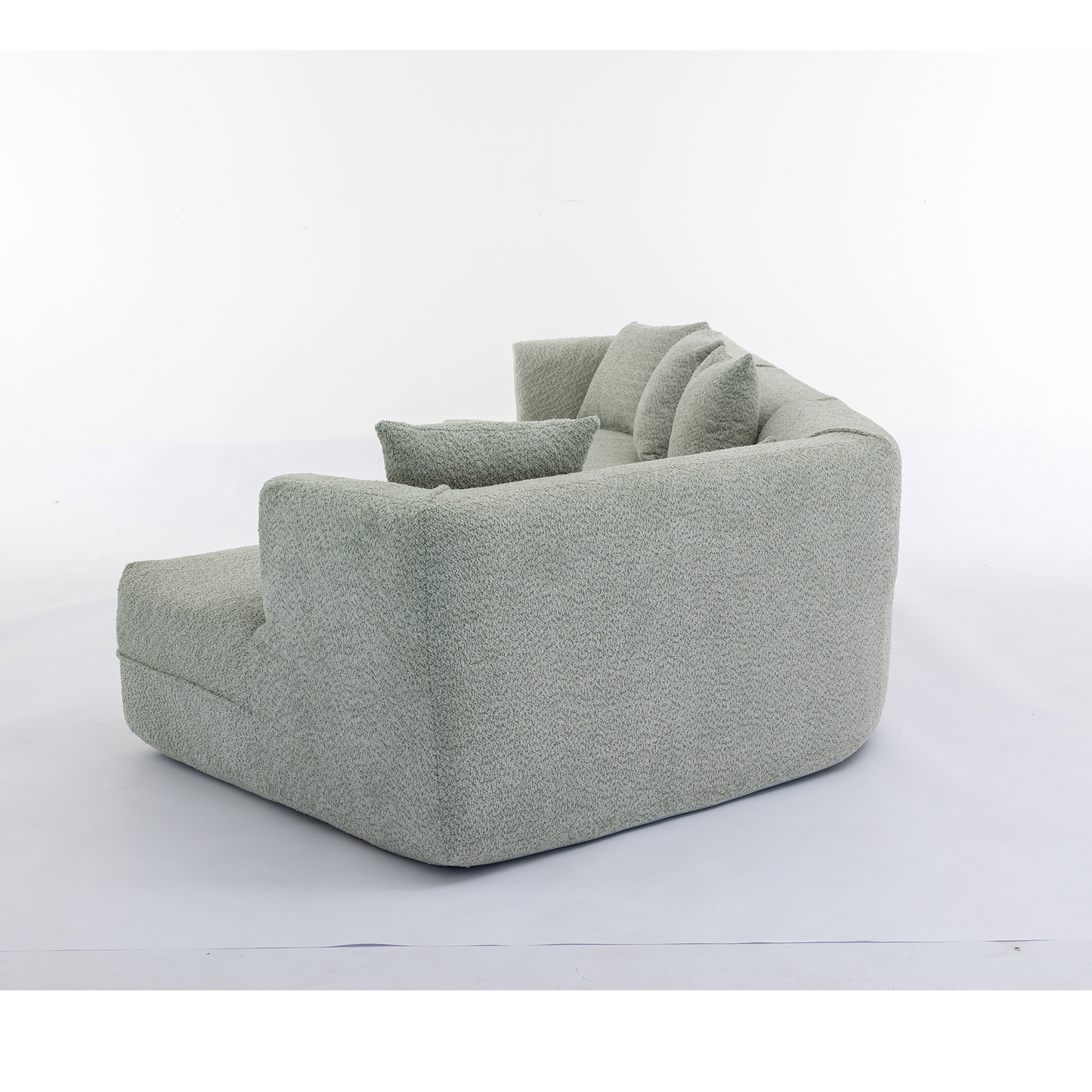 Plush sectional sofa in light green boucl fabric with loose back cushions