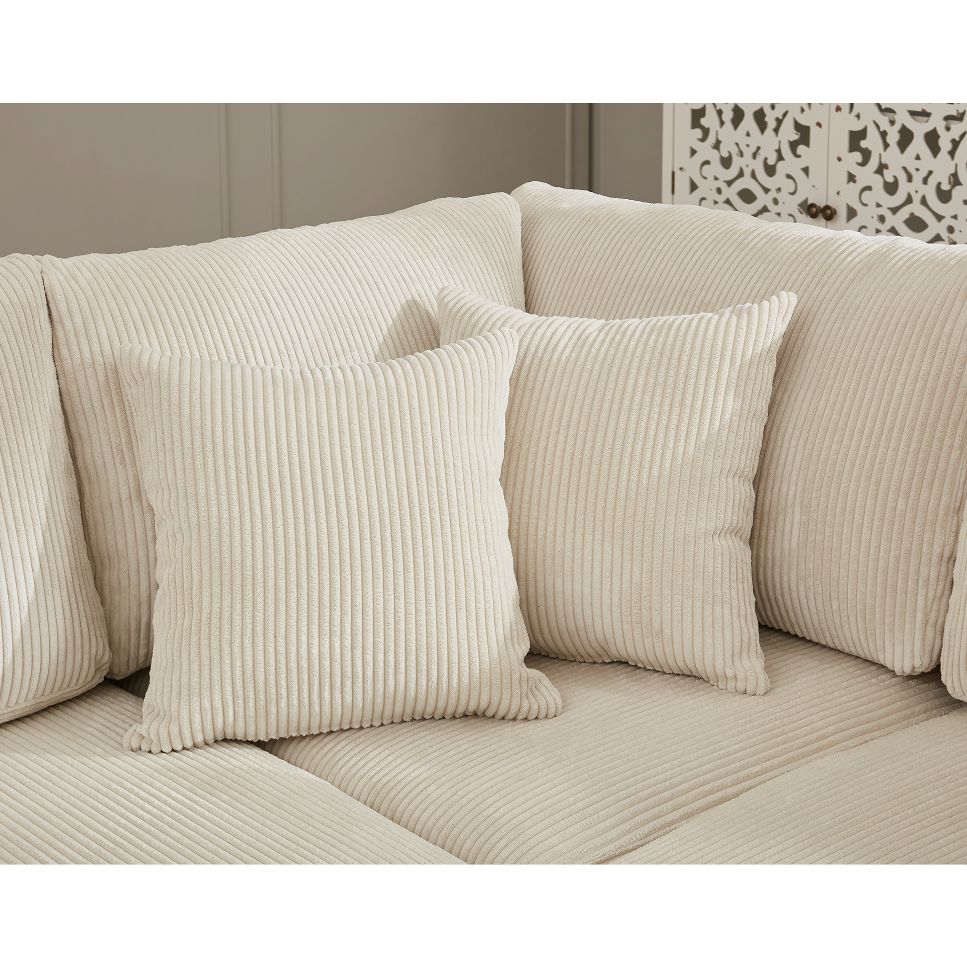 Plush cream corduroy sofa with matching throw pillows for a cozy living room