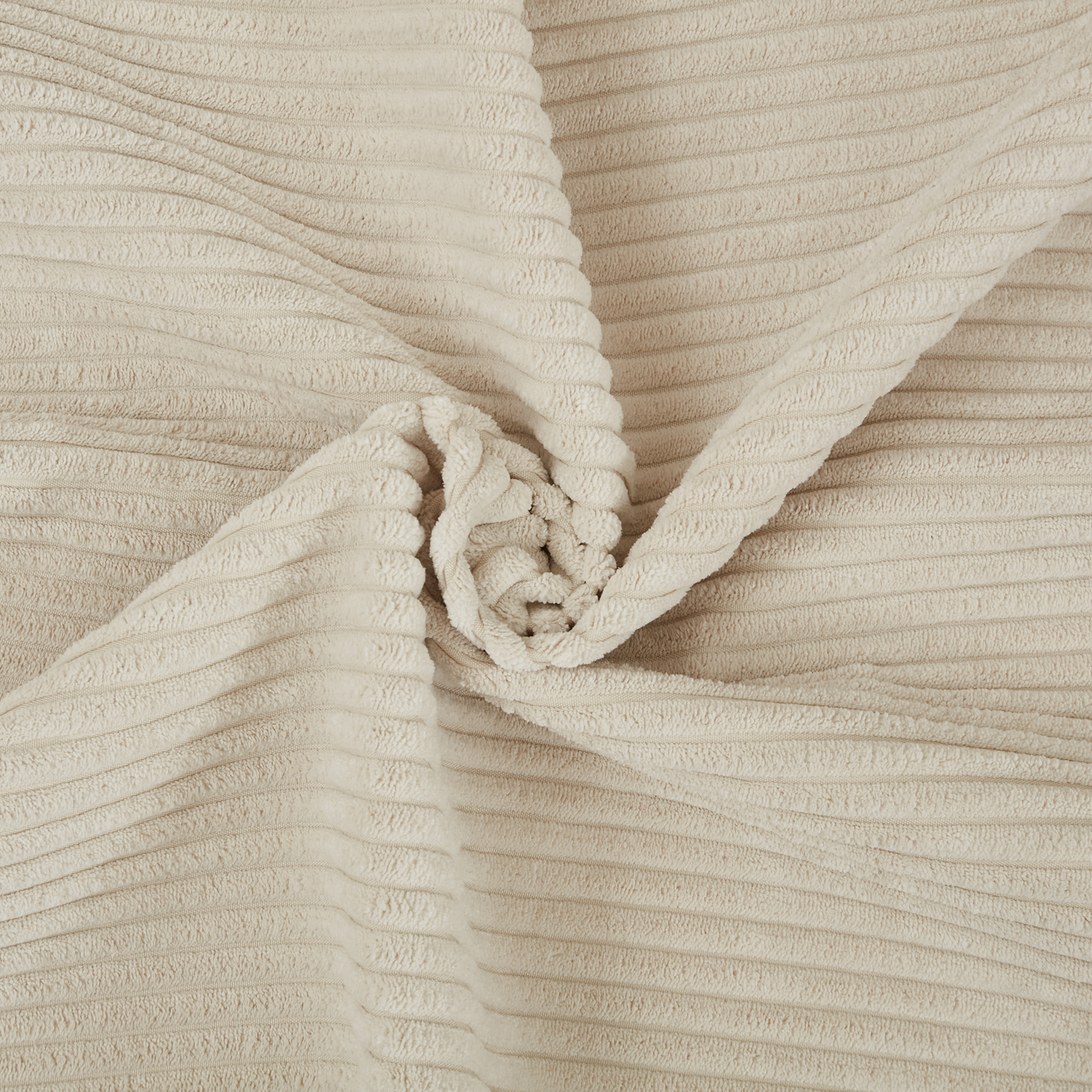 Cream widewale corduroy fabric with a soft plush texture and a swirl pattern