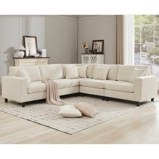 Cream corduroy sectional sofa with plush cushions and a draped throw blanket