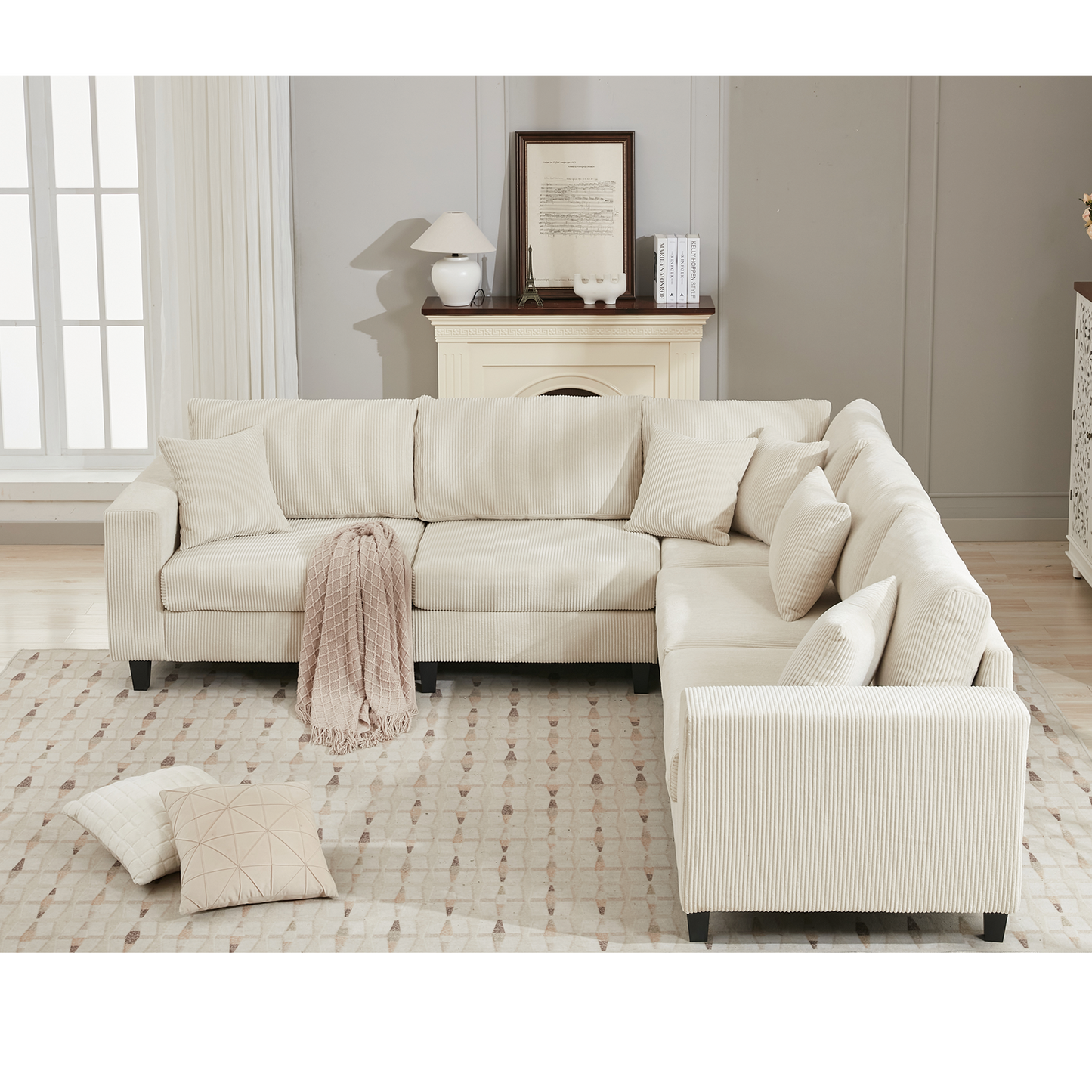 Cream corduroy sectional sofa with plush cushions and a beige throw