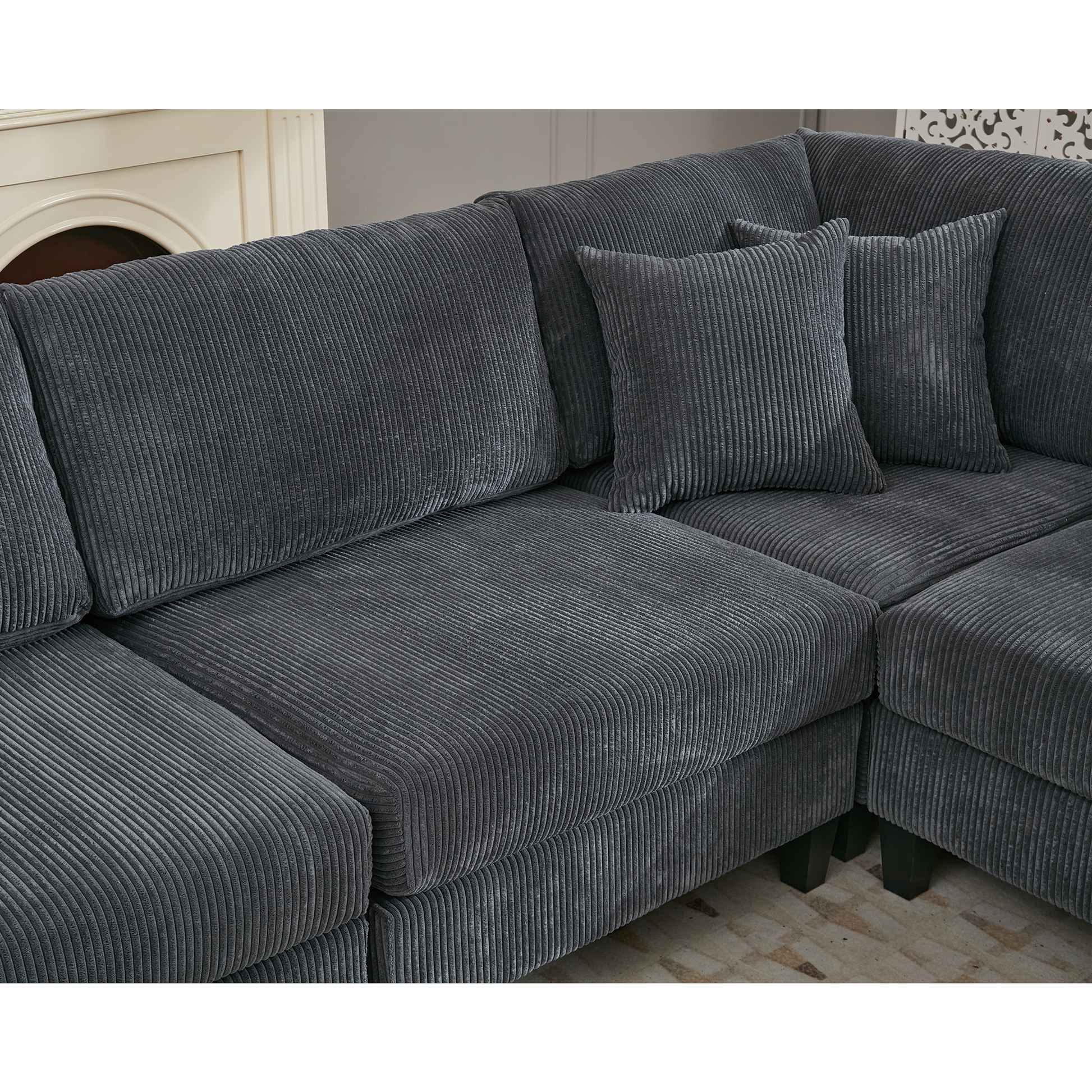 Dark grey corduroy sectional sofa with plush cushions and dark wood legs This sofa offers ultimate comfort for lounging