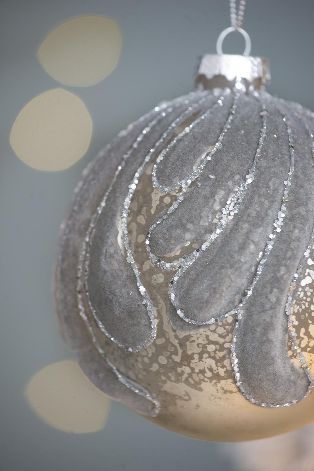 Silver flocked Christmas ornament with glitter swirl detail for festive decor