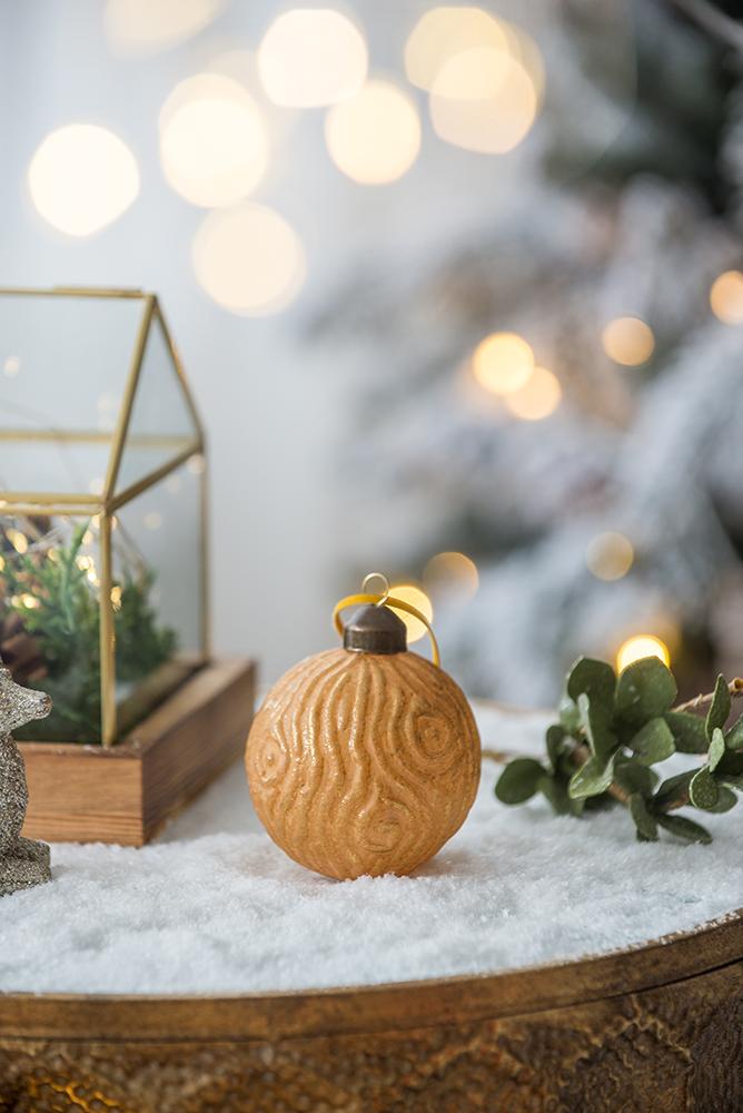 Textured gold Christmas ornament with swirling pattern and rustic charm