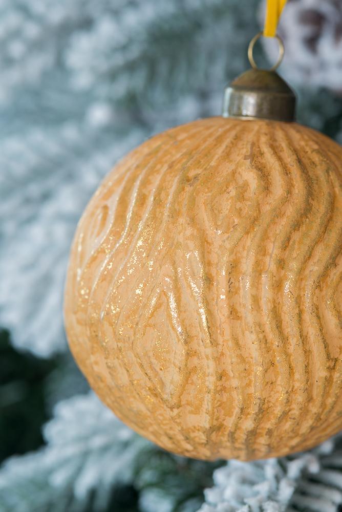 Textured orange bauble with subtle gold shimmer ideal for festive holiday decor