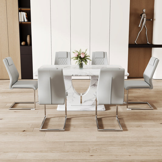 Marble dining table with six grey leather dining chairs in a modern setting