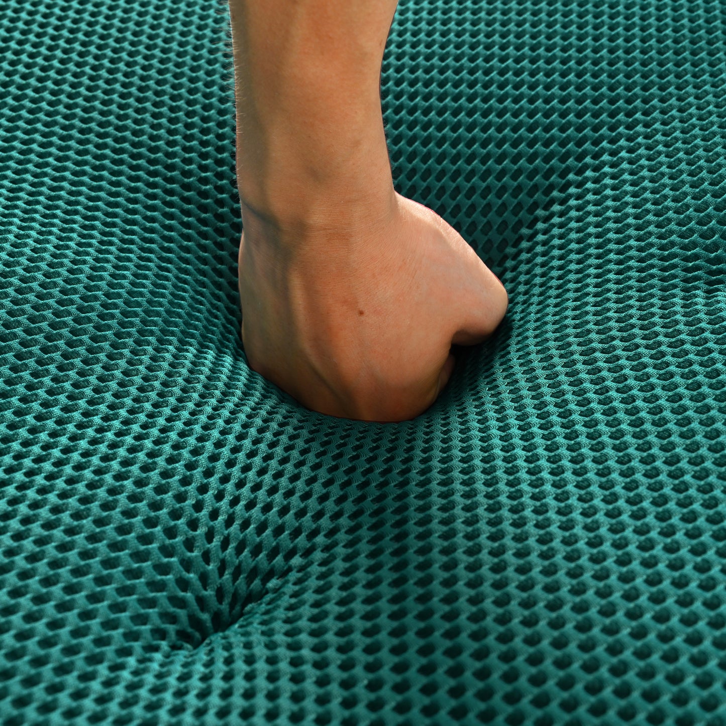 Deep green honeycomb foam mattress sample with hand impression
