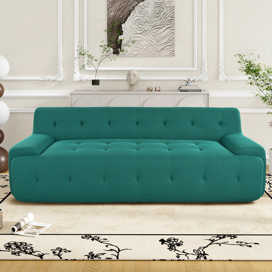 Teal fabric tufted sofa with modern button detailing perfect for living room seating