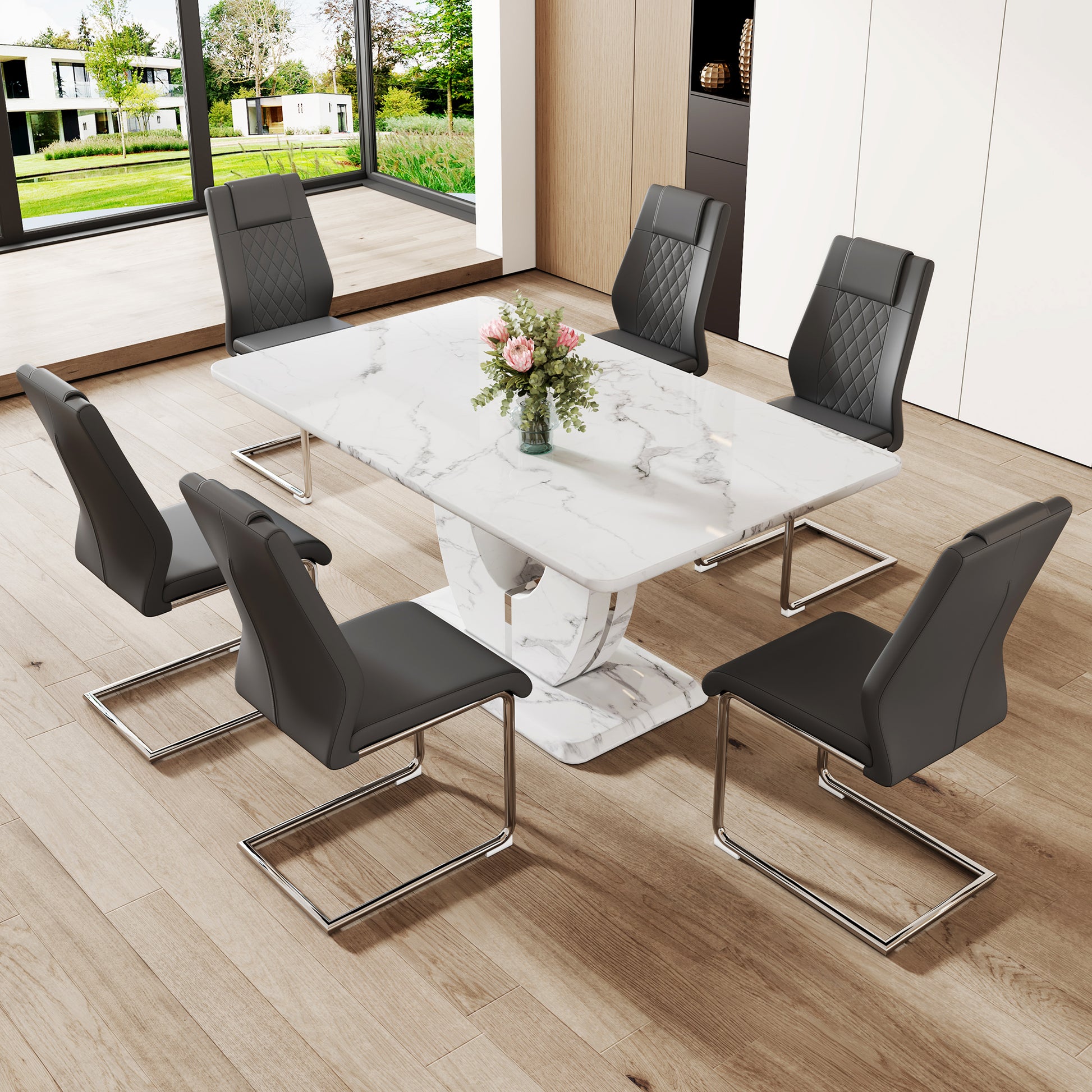Marble dining table with upholstered diamondstitched grey chairs around it