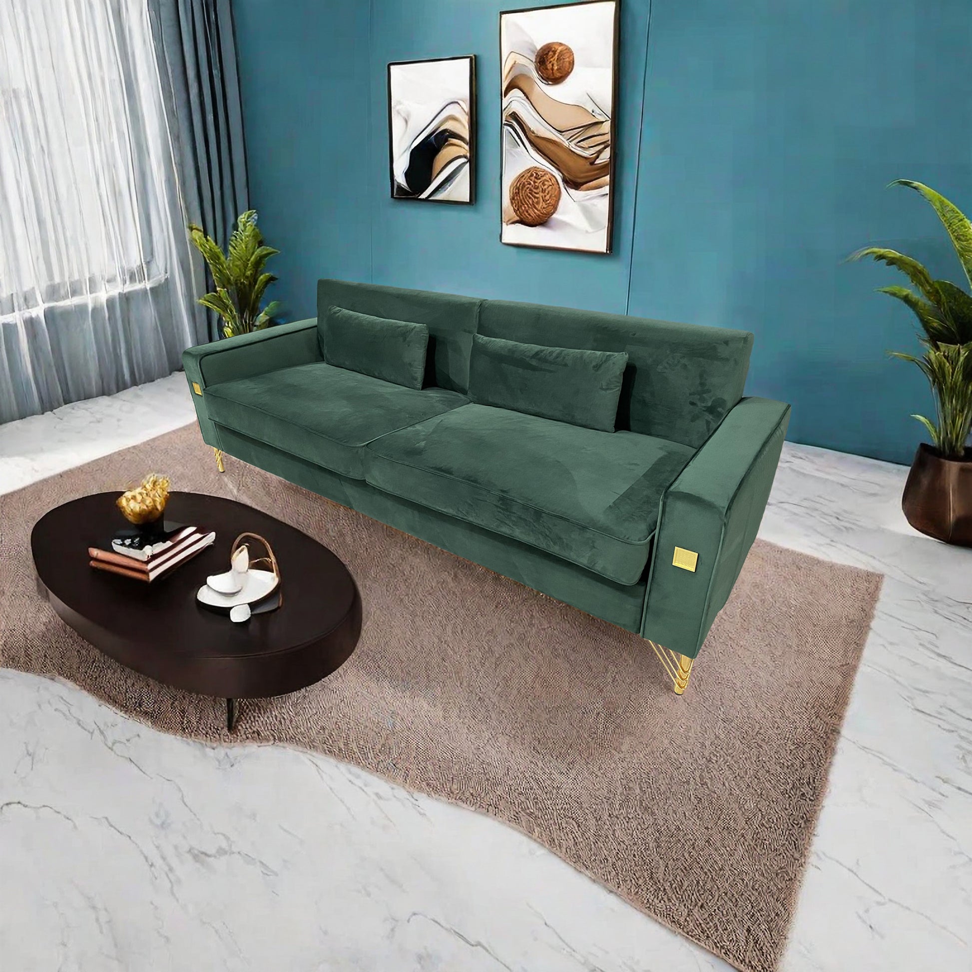 Deep green velvet sofa with gold accents and two throw pillows