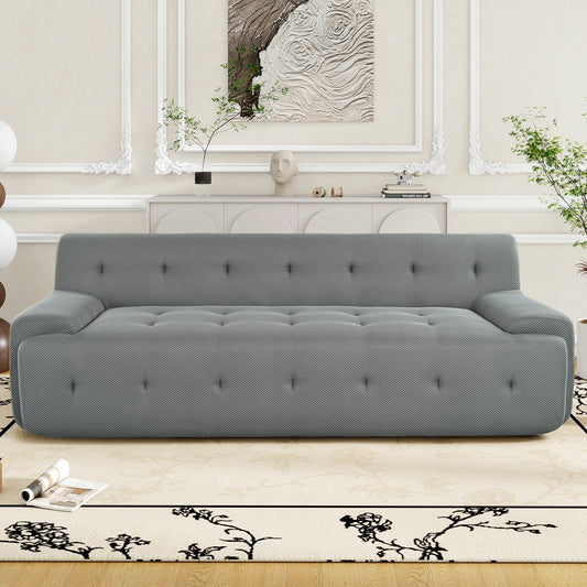 Gray upholstered sofa with tufted seat and button accents ideal for modern living rooms