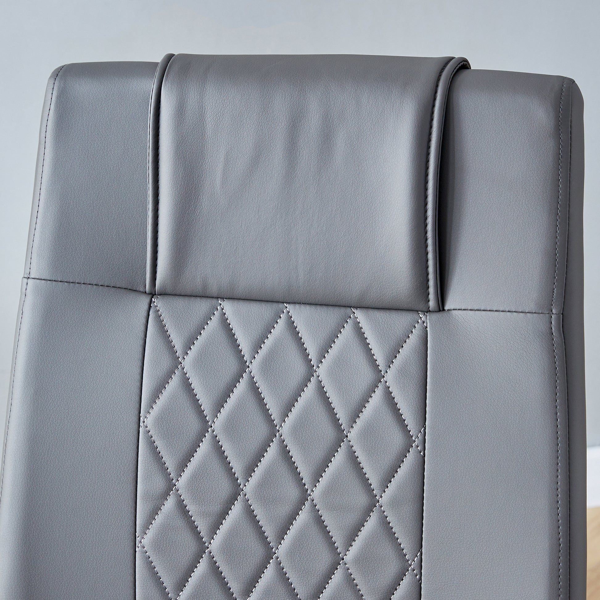 Gray faux leather office chair headrest with diamond stitching detail