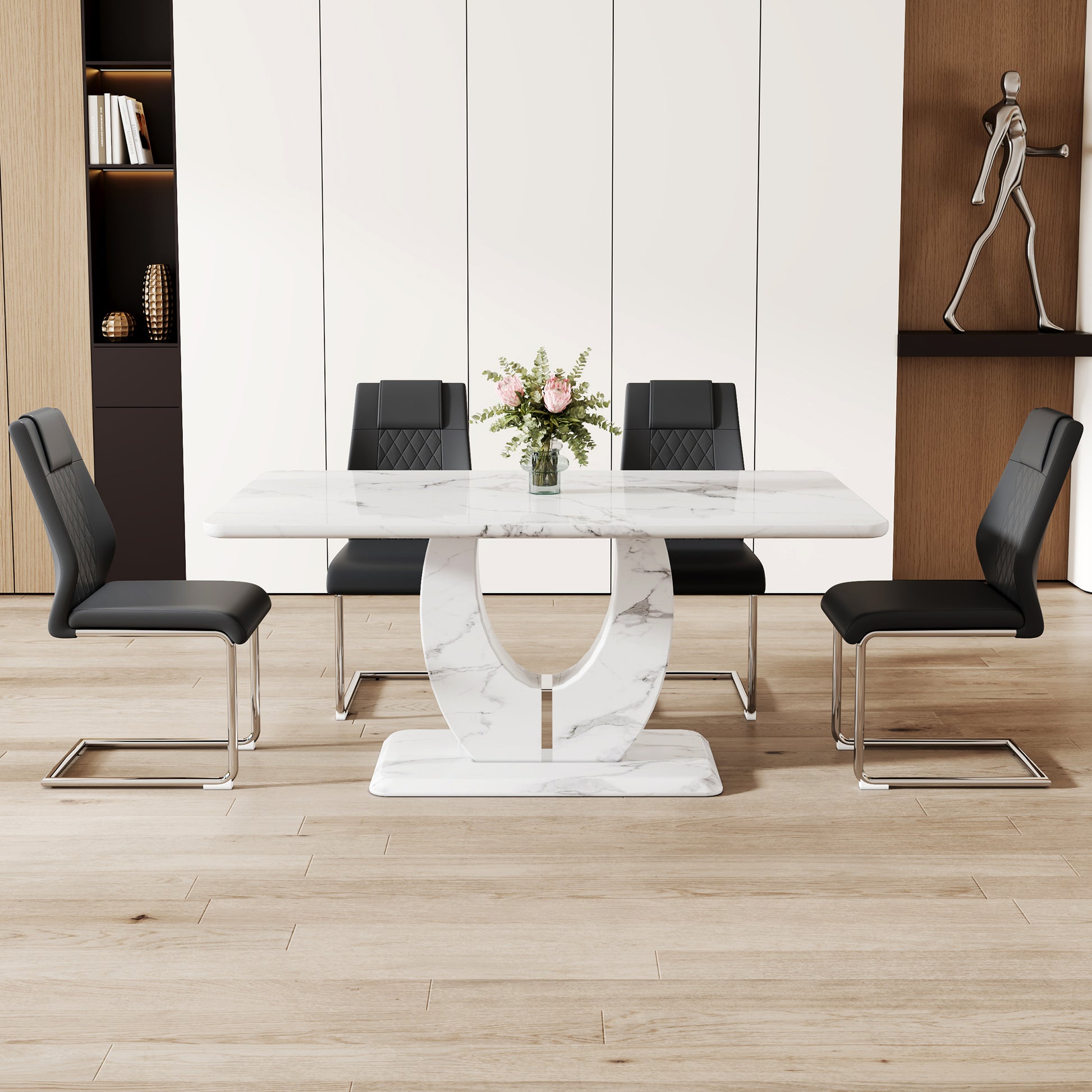 White marble dining table with curved pedestal base and four black faux leather chairs