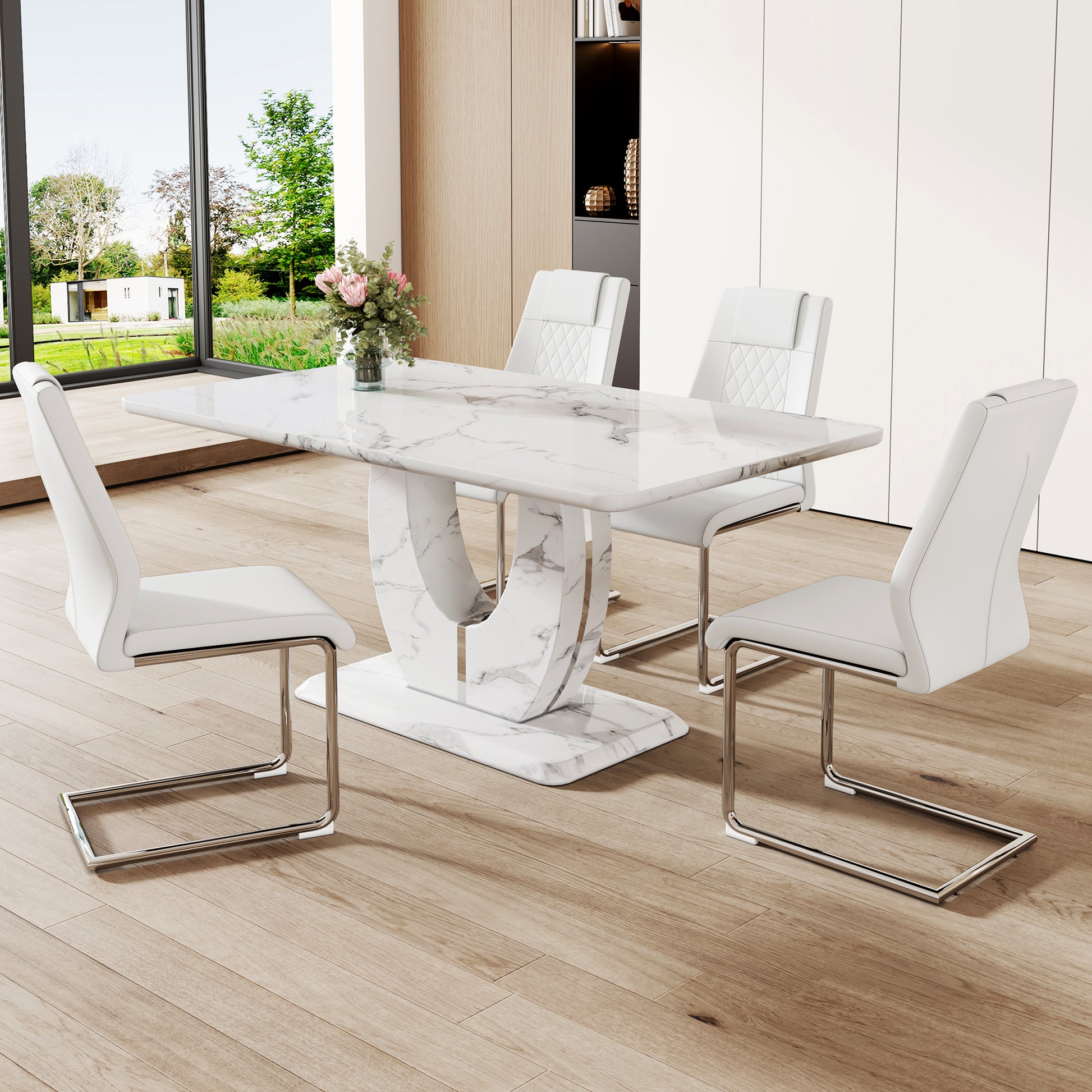 Modern white marble dining table with sleek white faux leather chairs and chrome legs