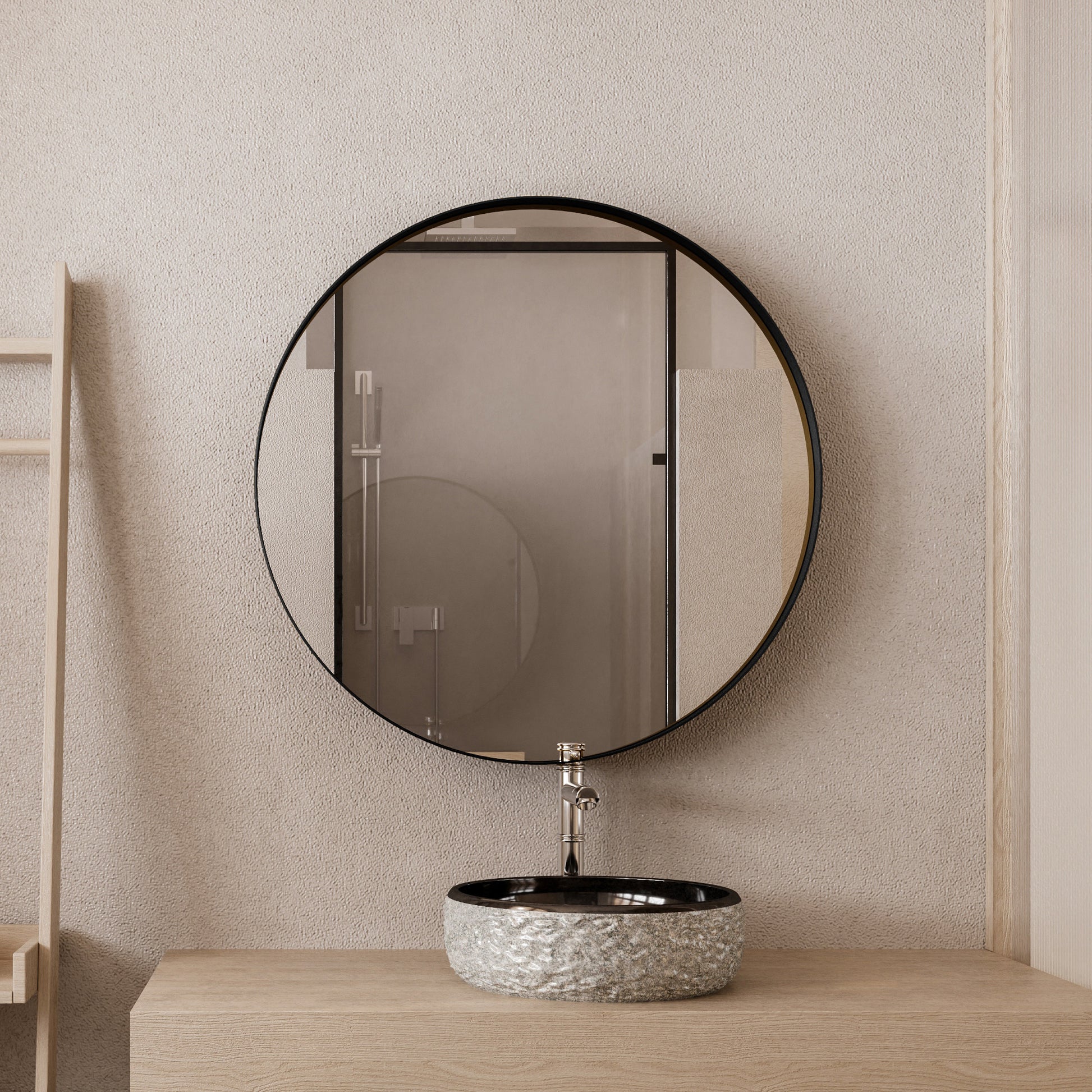 Textured stone vessel sink with chrome faucet and round blackframed mirror