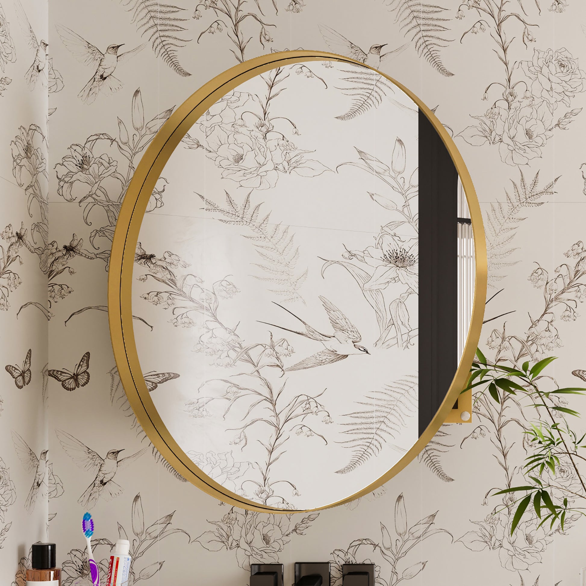 Round goldframed bathroom mirror with floral and bird wallpaper