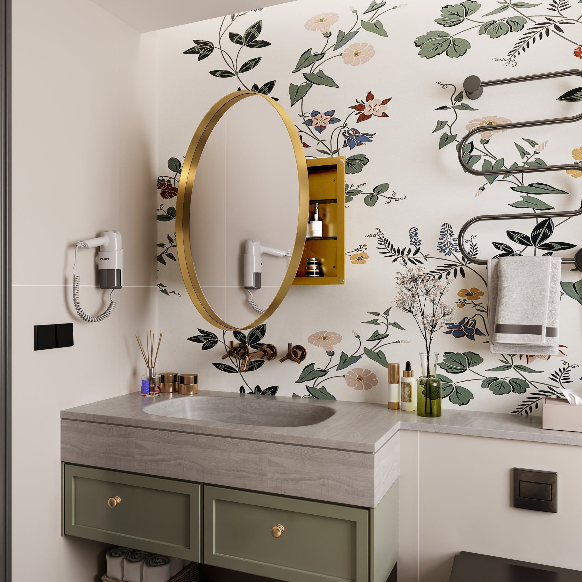 Gold oval bathroom mirror with floral wallpaper and a white hotel hairdryer attached to the wall